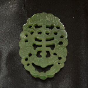 Carved Green Jade Pendant - Intricate Filigree Design